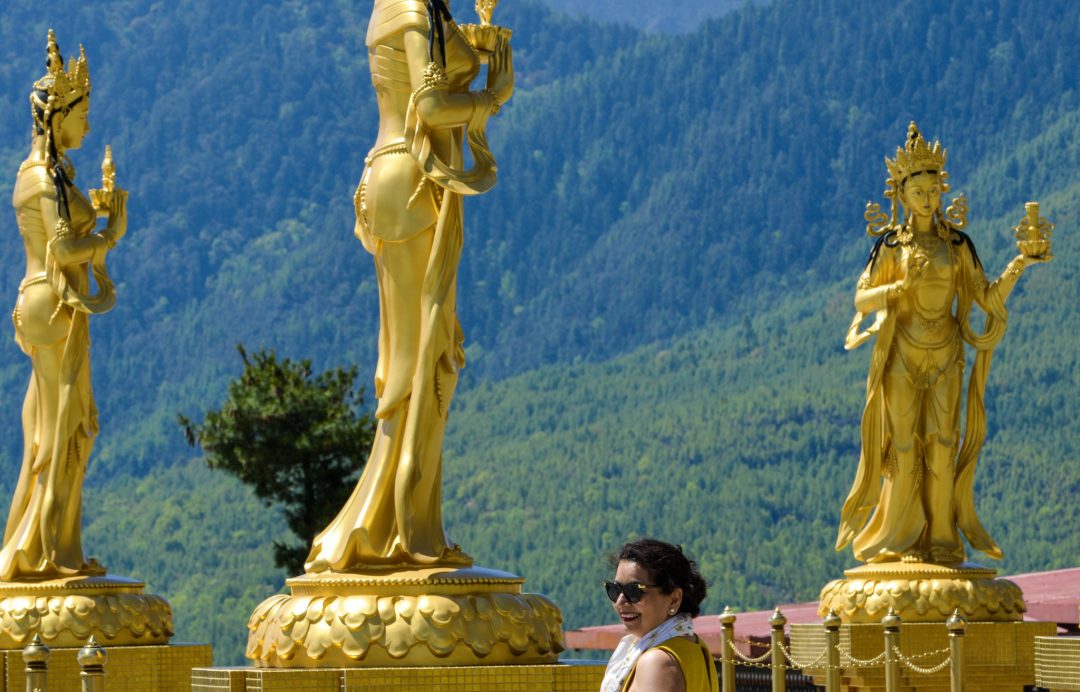 Lady standing at Buddha Dordenma in Bhutan