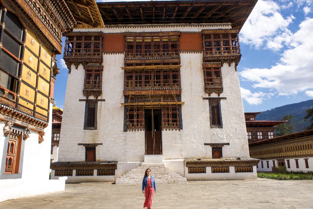 Tourist in front of Tashichhodzong (Thimphu Dzong) during our our 7 day Bhutan Itinerary 