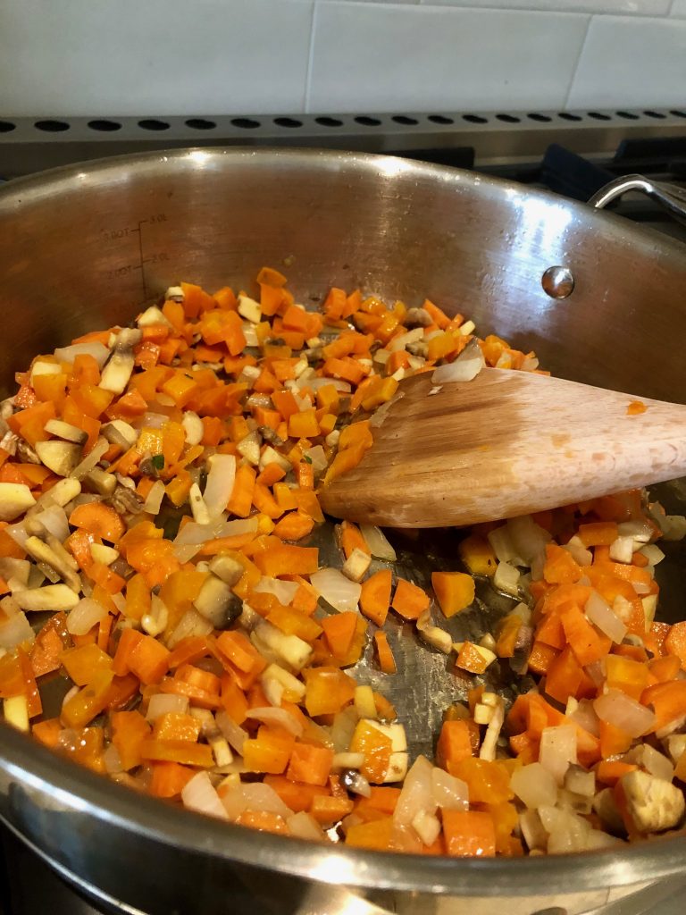 Add carrots, mushrooms and pepper to the onions.